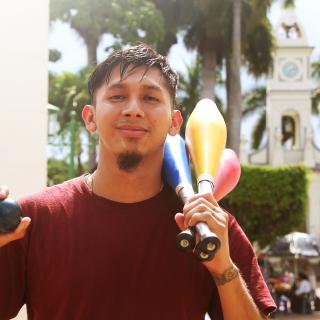 Young man with juggling equipment